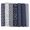 A pack of seven vertically striped and patterned cotton fabric squares for quilting and patchwork projects.