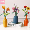 A floral bouquet building block set featuring colorful flowers and greenery displayed in a vase.