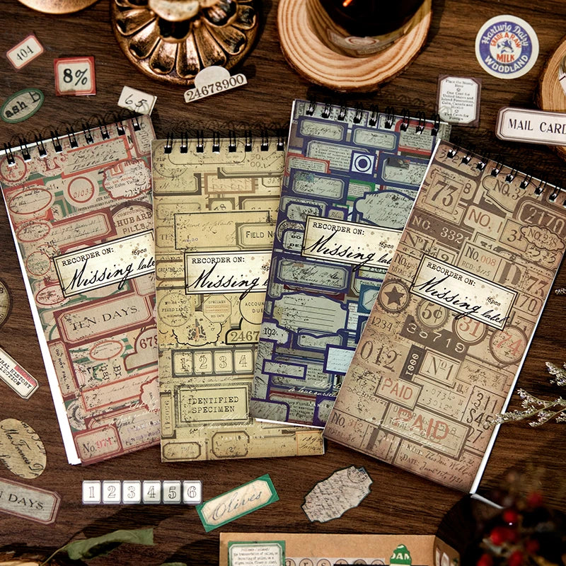 A collection of vintage label stickers and paper scraps arranged on a wooden surface for scrapbooking.
