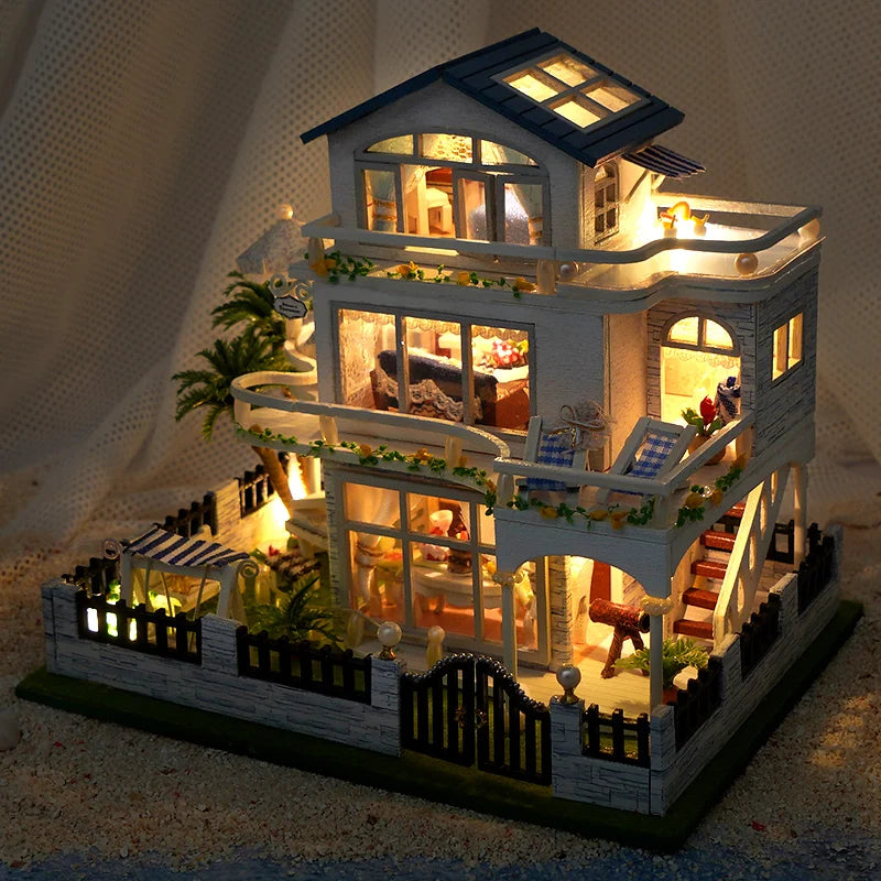 A detailed wooden mini seaside villa dollhouse kit featuring a two-story structure with windows and exterior landscaping.