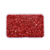 A clear plastic container filled with red crushed glass stones for resin and craft projects.