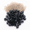 A pile of black plastic safety eyes with washers for crafting and stuffed animals