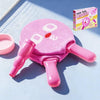 A pink handheld smoke bubble wand with a pink handle and a box in the background.