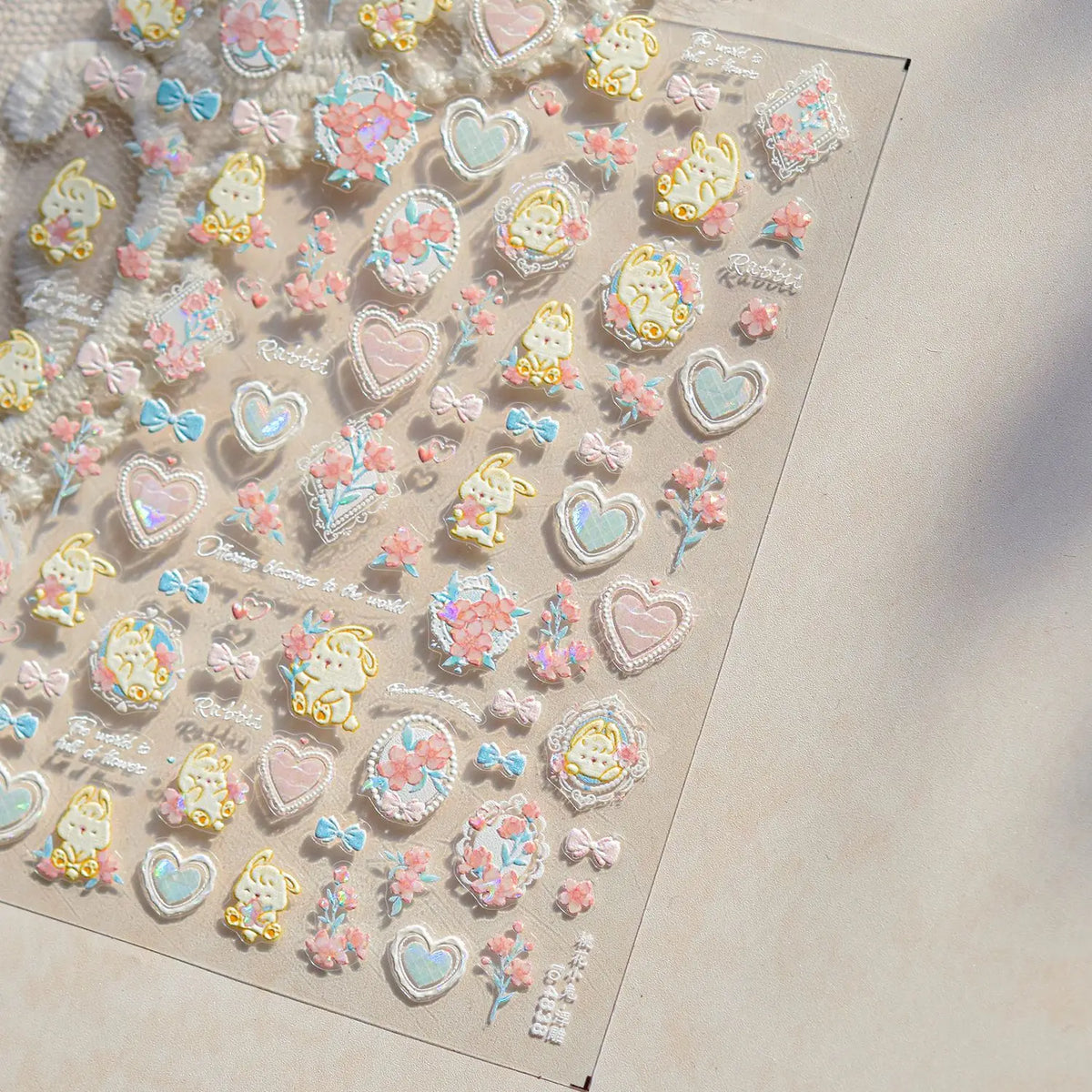 A collection of pink, blue, and yellow heart-shaped nail art stickers for acrylic nails.