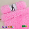 Pink faux fur yarn in a skein with a black fox design and a tag showing 4 pieces weighing 400 grams