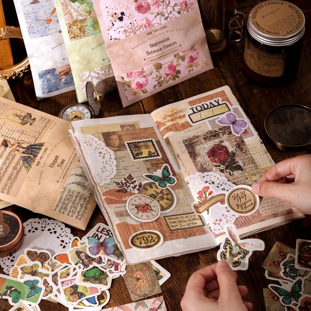 A collection of vintage stickers and paper elements for crafting laid out on a wooden surface.