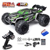 A green and black 4WD monster truck RC car with large tires and accessories shown on a white background.