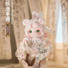 A delicate porcelain figurine of a girl with white hair and pink accents, dressed in traditional clothing.