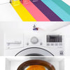 A hand dips a piece of fabric into a bowl of orange liquid dye for clothes and crafts.