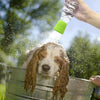 A dog is being showered with water from a portable silicone pet shower head.