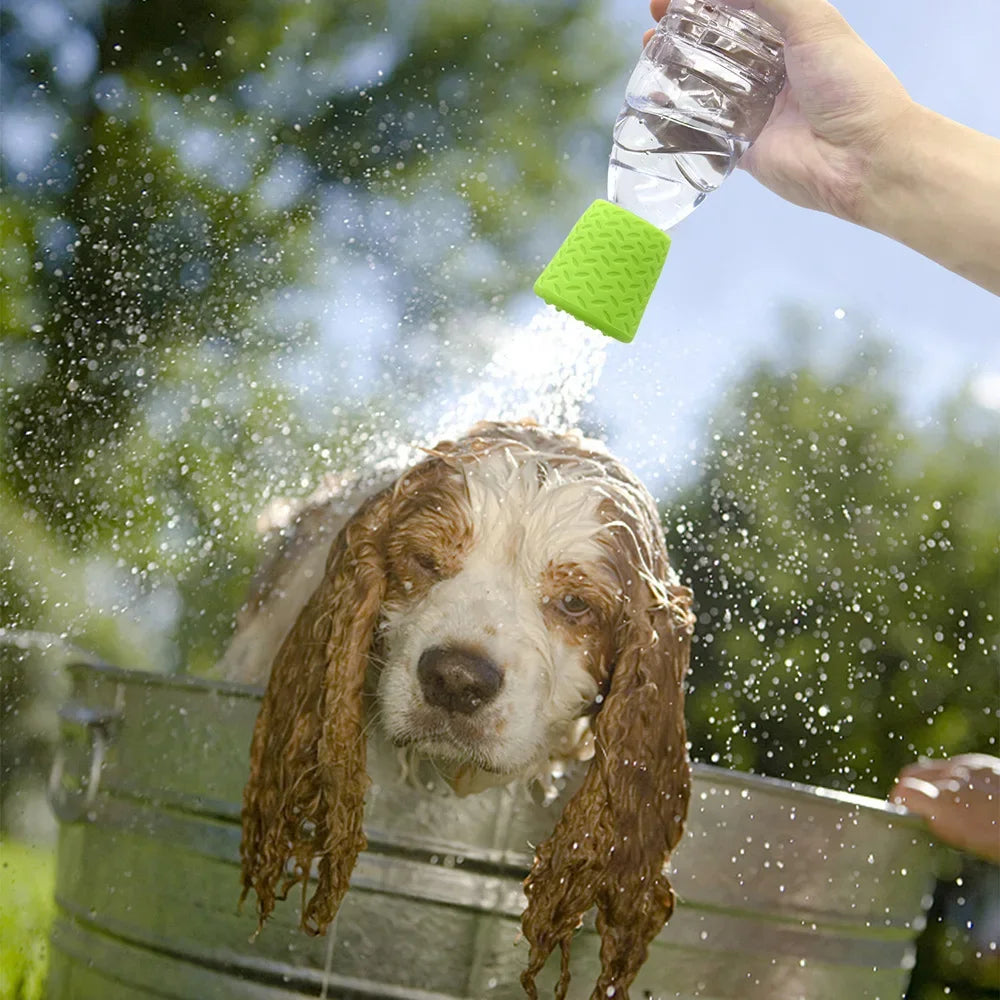 A dog is being showered with water from a portable silicone pet shower head.