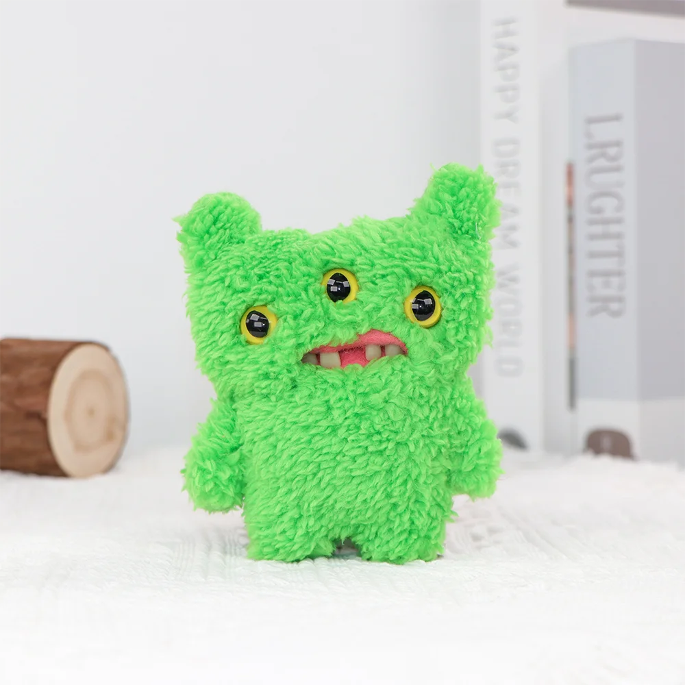 A bright green, fuzzy monster plush toy with yellow eyes sits on a white surface.