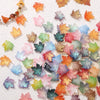 A collection of colorful maple leaf glass beads for DIY jewelry making