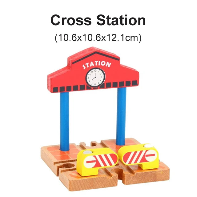 A red wooden cross station model with a clock and blue support posts, placed on a wooden track base.