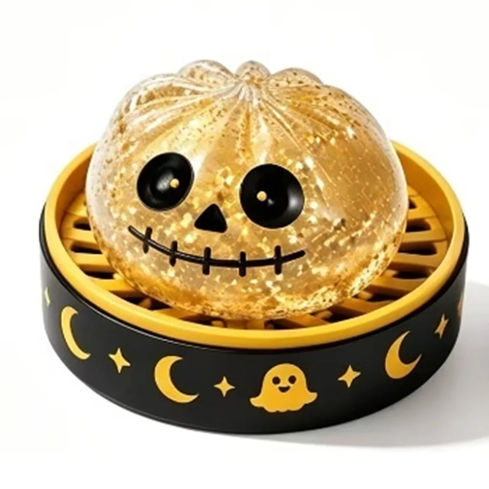 A golden pumpkin-shaped squishy fidget toy with a carved face sits in a yellow and black slotted container.