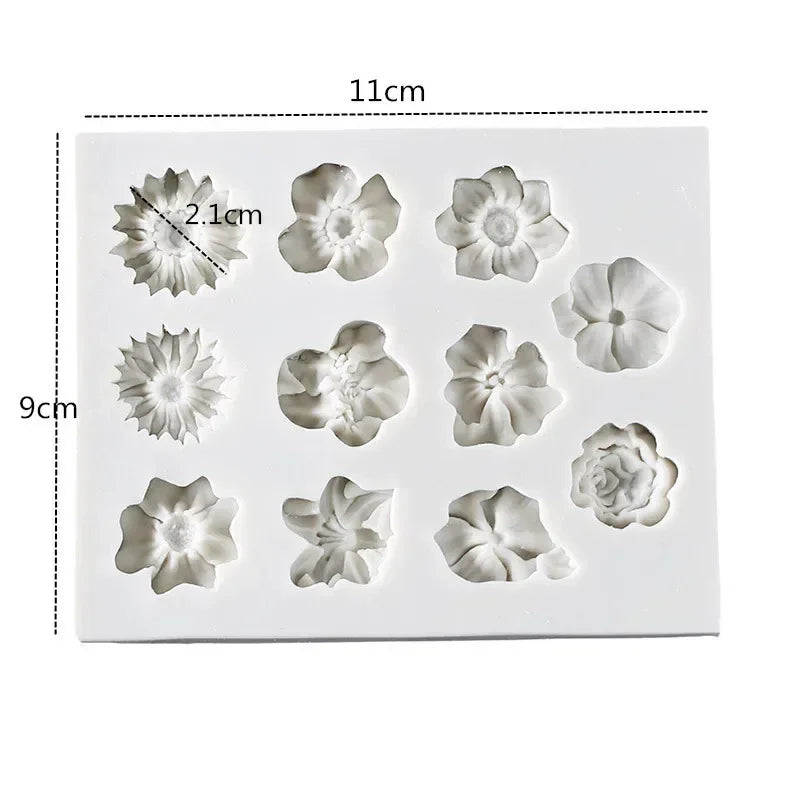 A silicone mold set featuring various flower shapes for chocolate and cake decorating, including sunflowers and roses.
