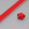A red glitter paper strip is shown next to a folded red origami star.