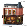 A detailed wooden dollhouse kit of a red brick restaurant building with large windows and a dark roof.