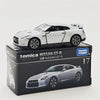 A Tomica Nissan GT-R die-cast model car in silver and black on its packaging.