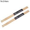 A pair of light wood drumsticks labeled 7A, showing the wooden shaft and black grip.