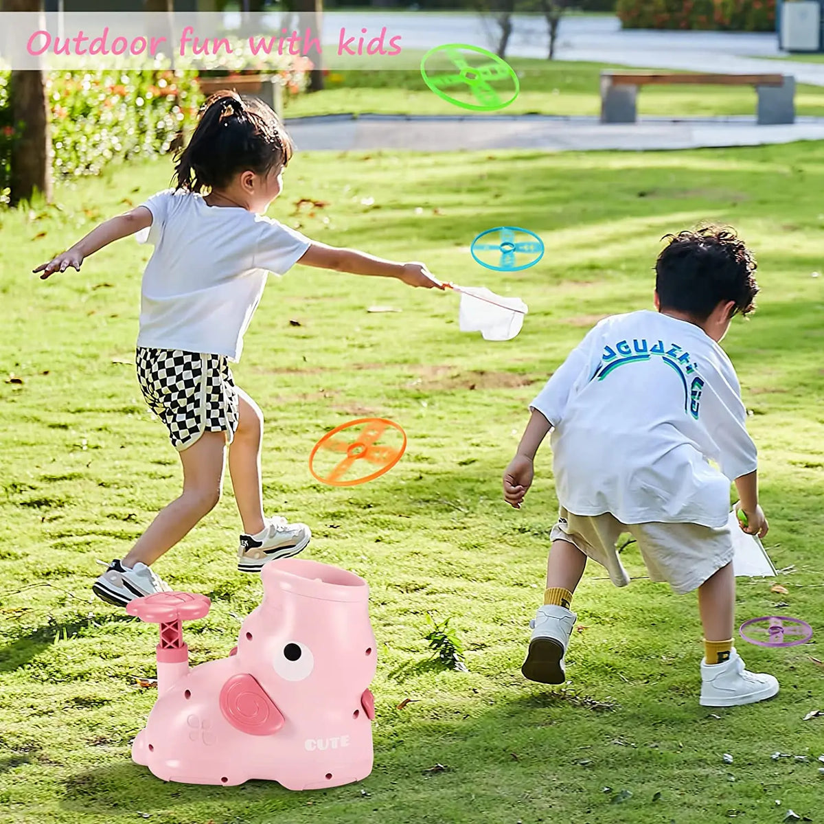 A young girl is playing with a pink foot launcher toy and flying discs outdoors.