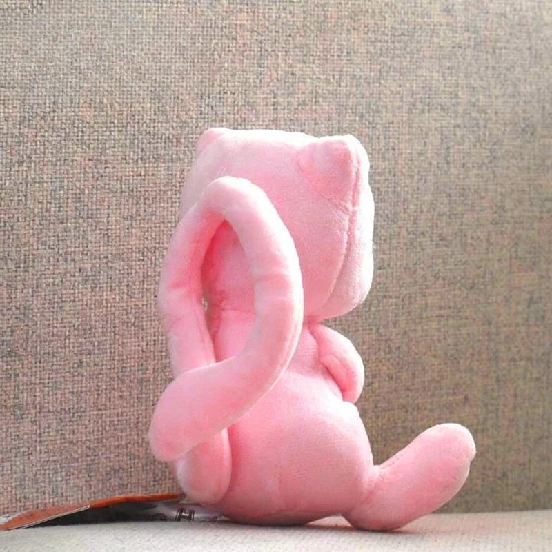 A soft pink kawaii anime plush doll with large ears is shown against a neutral background.