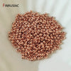 A pile of small, round, rose gold-colored spacer beads for jewelry making.