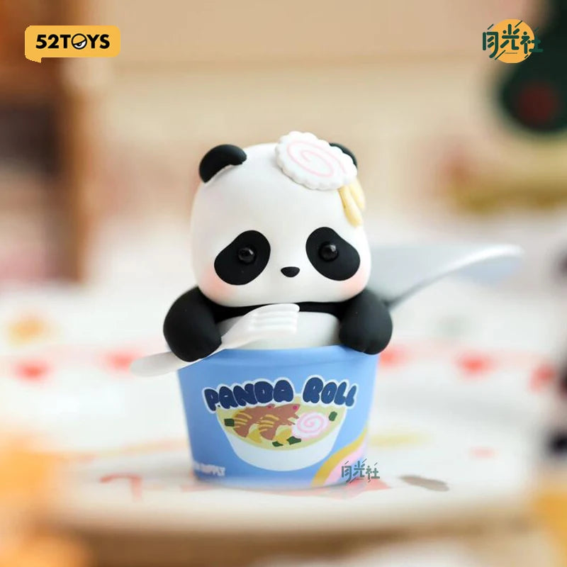 A cute panda collectible figure is shown sitting in a blue cup with a panda roll design.