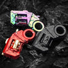 A collection of metal gun-shaped fidget sliders in various colors, including pink, yellow, and black, resting on a dark, text