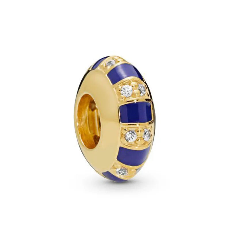 A gold-toned charm bracelet featuring elephant, key, butterfly, and heart pendants set in blue and white enamel.