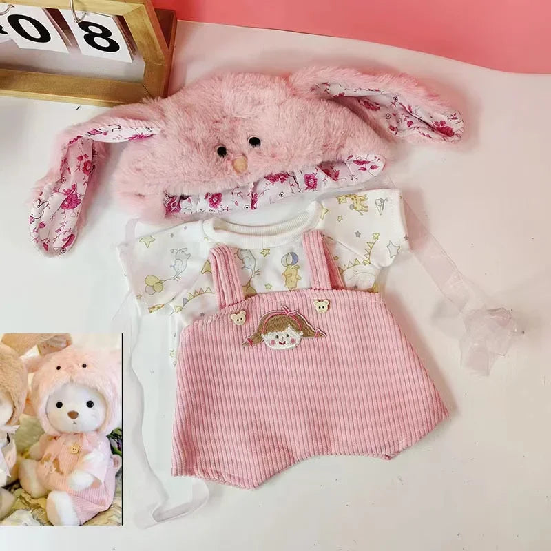 A pink fluffy rabbit plush toy and a matching pink ribbed dress are displayed on a white surface.