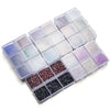 A clear plastic tray filled with various colors of crushed glass stones for resin and craft projects