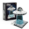 A box set for building a UFO alien spaceship model featuring a detailed spacecraft and a clear blue liquid display.