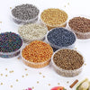 A collection of various colored electroplated metallic glass beads for jewelry and crafting, displayed in clear containers.