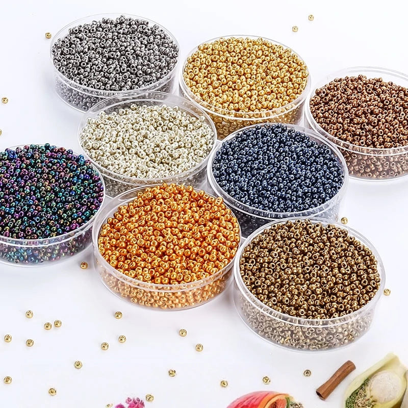 A collection of various colored electroplated metallic glass beads for jewelry and crafting, displayed in clear containers.