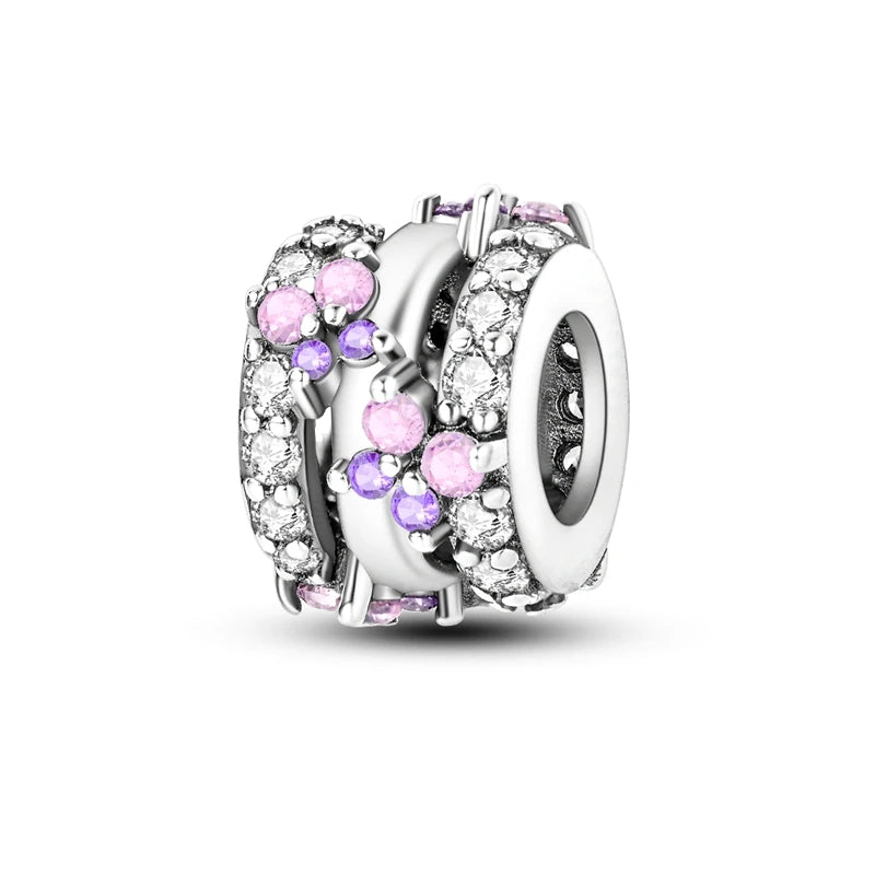 A silver heart charm bead featuring pink zircon stones and detailed craftsmanship.