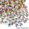 A pile of sparkling crystal AB gold base rhinestones for nail art and crafts.