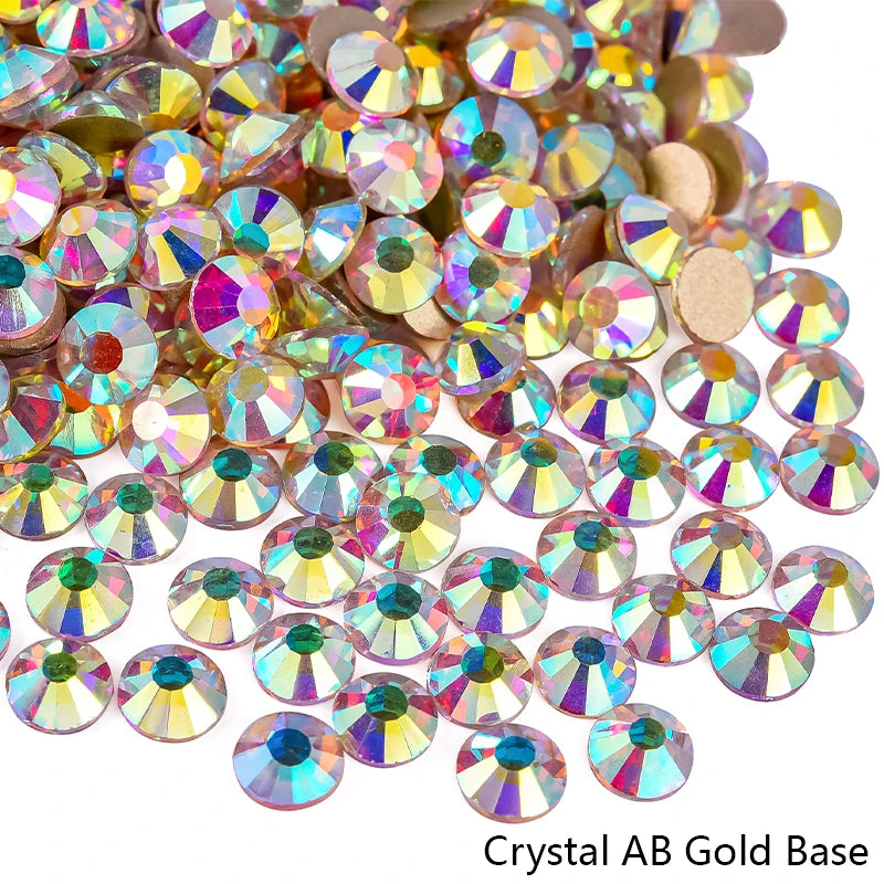 A pile of sparkling crystal AB gold base rhinestones for nail art and crafts.