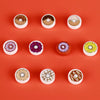 A collection of colorful mini food building blocks including pizza, cake, and condiment shaped pieces arranged in a row.