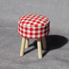 A red and white checkered mini sofa and pillow set for a dollhouse