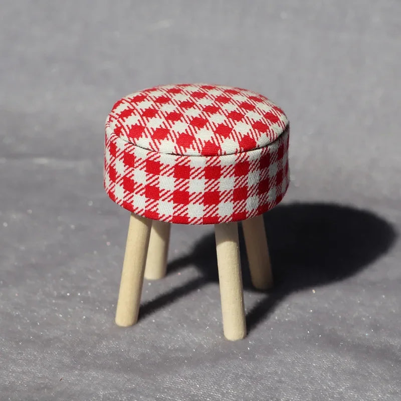 A red and white checkered mini sofa and pillow set for a dollhouse
