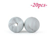 Two round, marbled silicone beads in light gray are shown against a white background.