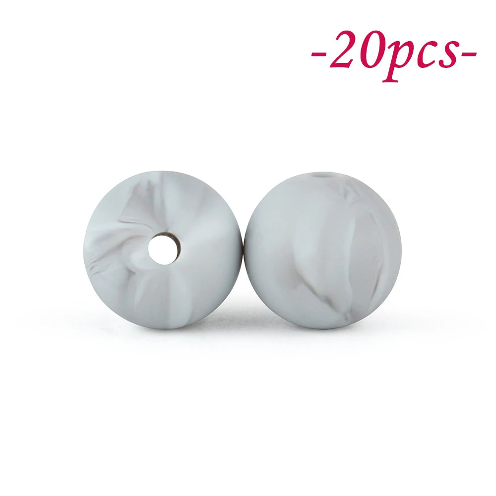 Two round, marbled silicone beads in light gray are shown against a white background.