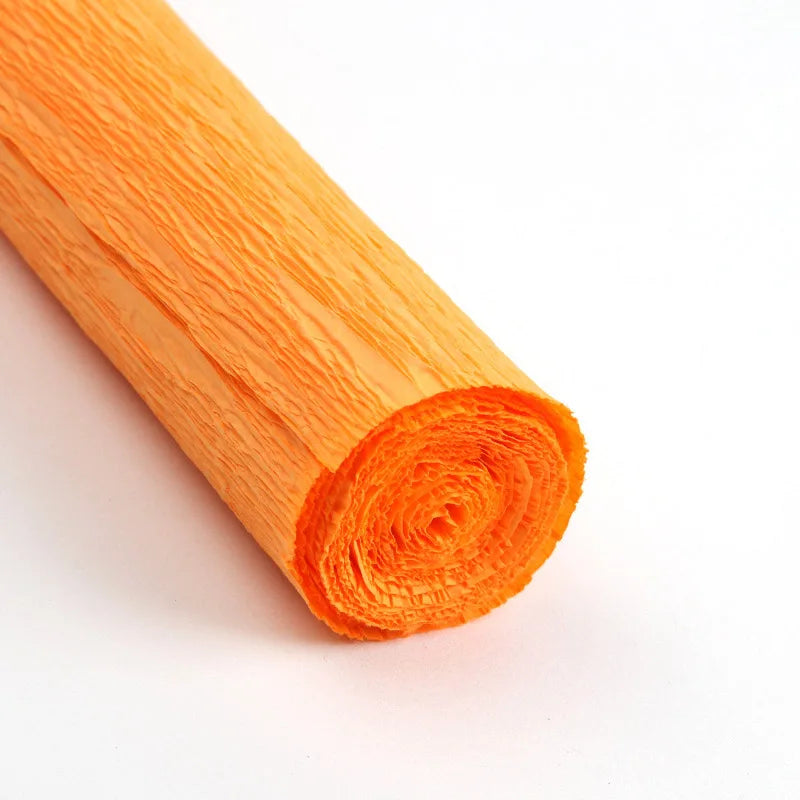 A roll of bright orange crepe paper for DIY crafts and gift wrapping.