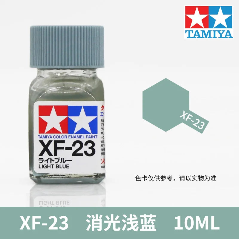 Tamiya XF-23 Light Blue enamel paint in a glass bottle, labeled as a model building paint.