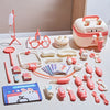 A pink kids doctor play set featuring various medical tools, including a stethoscope and various plastic instruments.