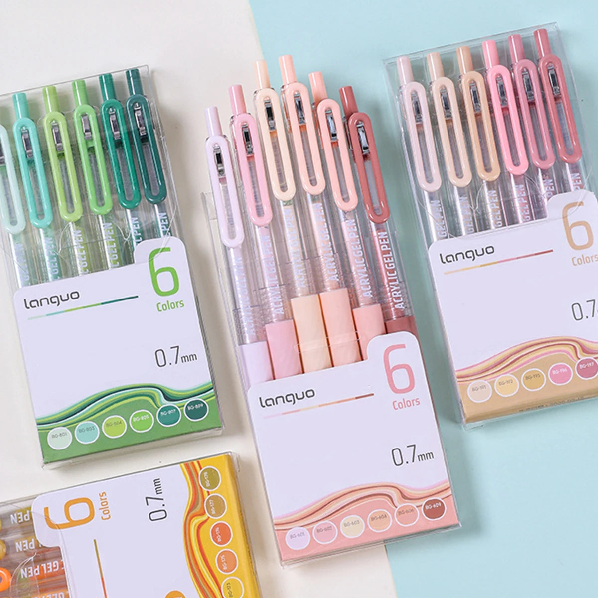 A collection of six pink and green retractable gel pens with 0.7mm tips displayed in clear packaging.