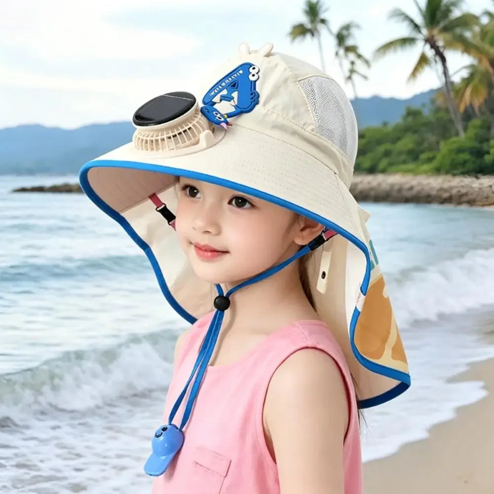 A young woman wearing a beige sun hat with a blue fabric and a USB charging fan attached, standing near the ocean.