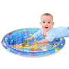 A baby is interacting with a colorful circular water play mat featuring various sea creatures and learning elements.