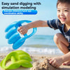 A smiling child is using a blue dinosaur claw sand digging toy to dig in the sand.